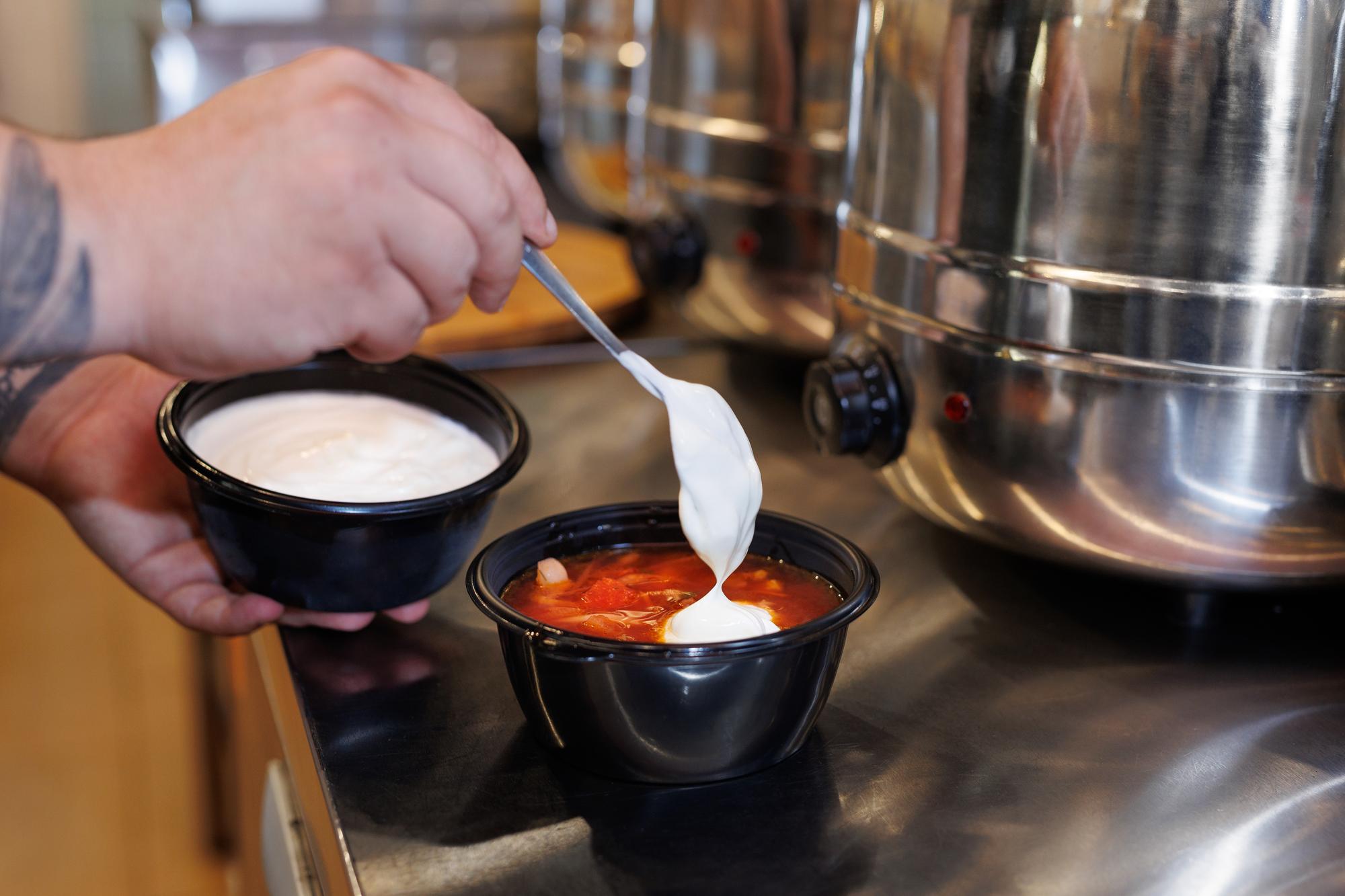 Chef tasting sauce at stove