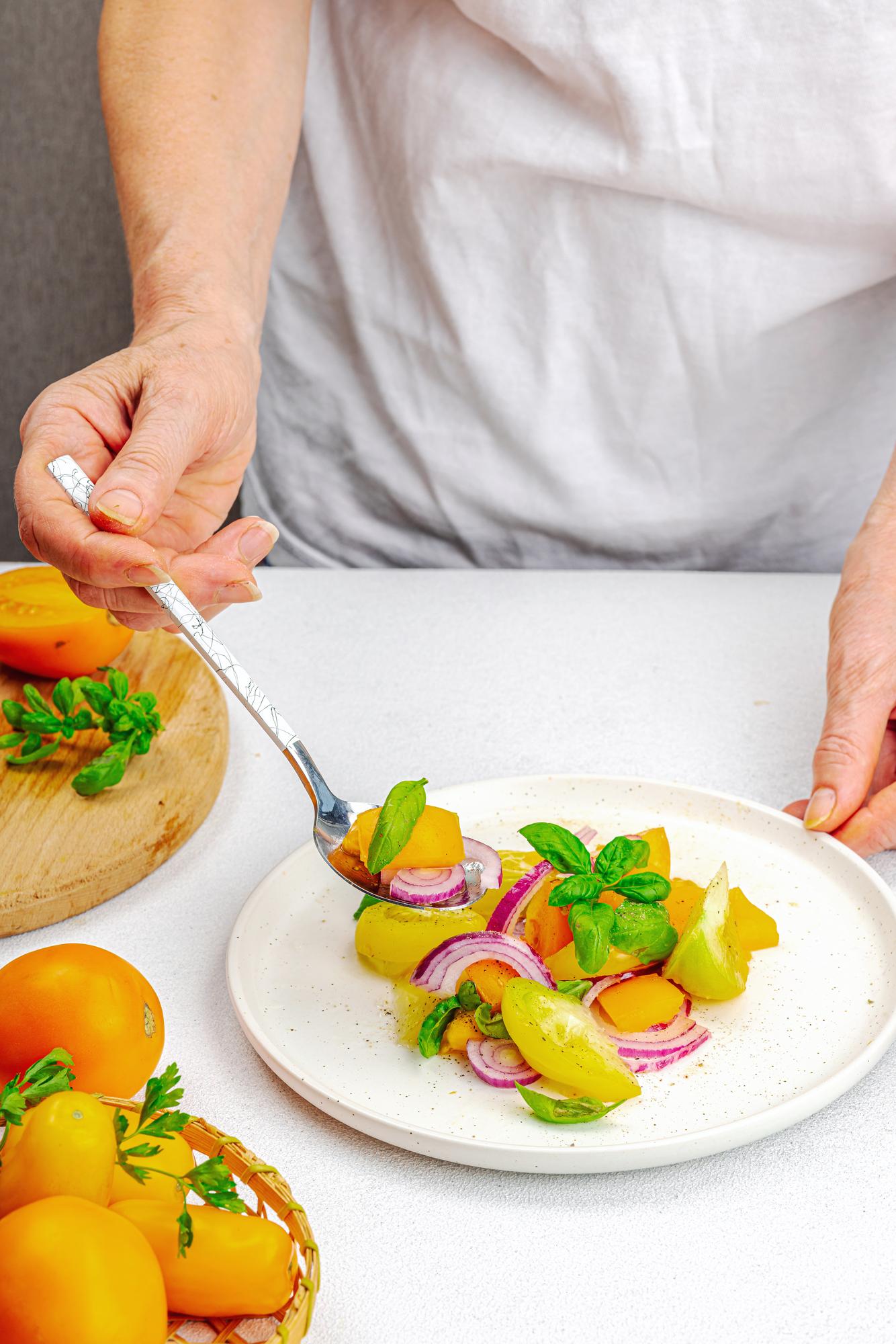 Chef arranging plated dish on wooden table